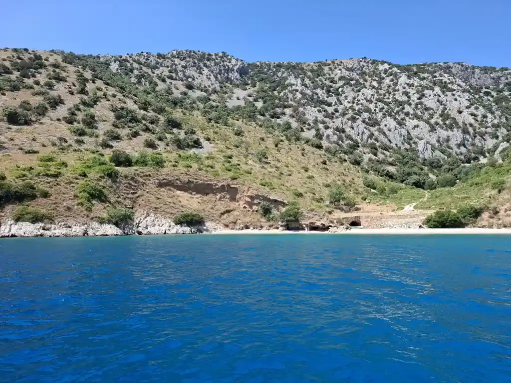 White pebble beach and hidden caves in a wild cove on the south side of Brač